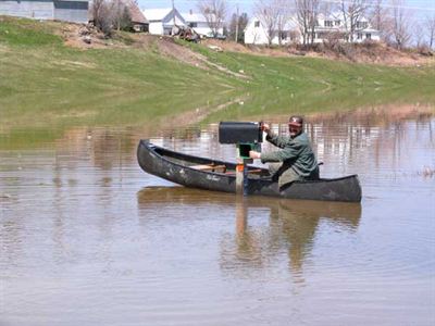 Resident canoeing to check the mail