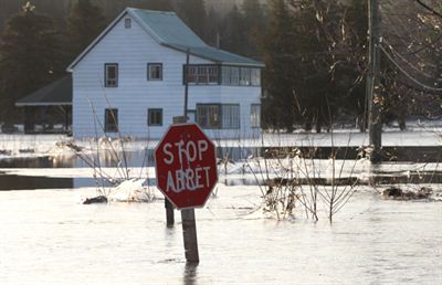 A stop sign is submerged at the intersection